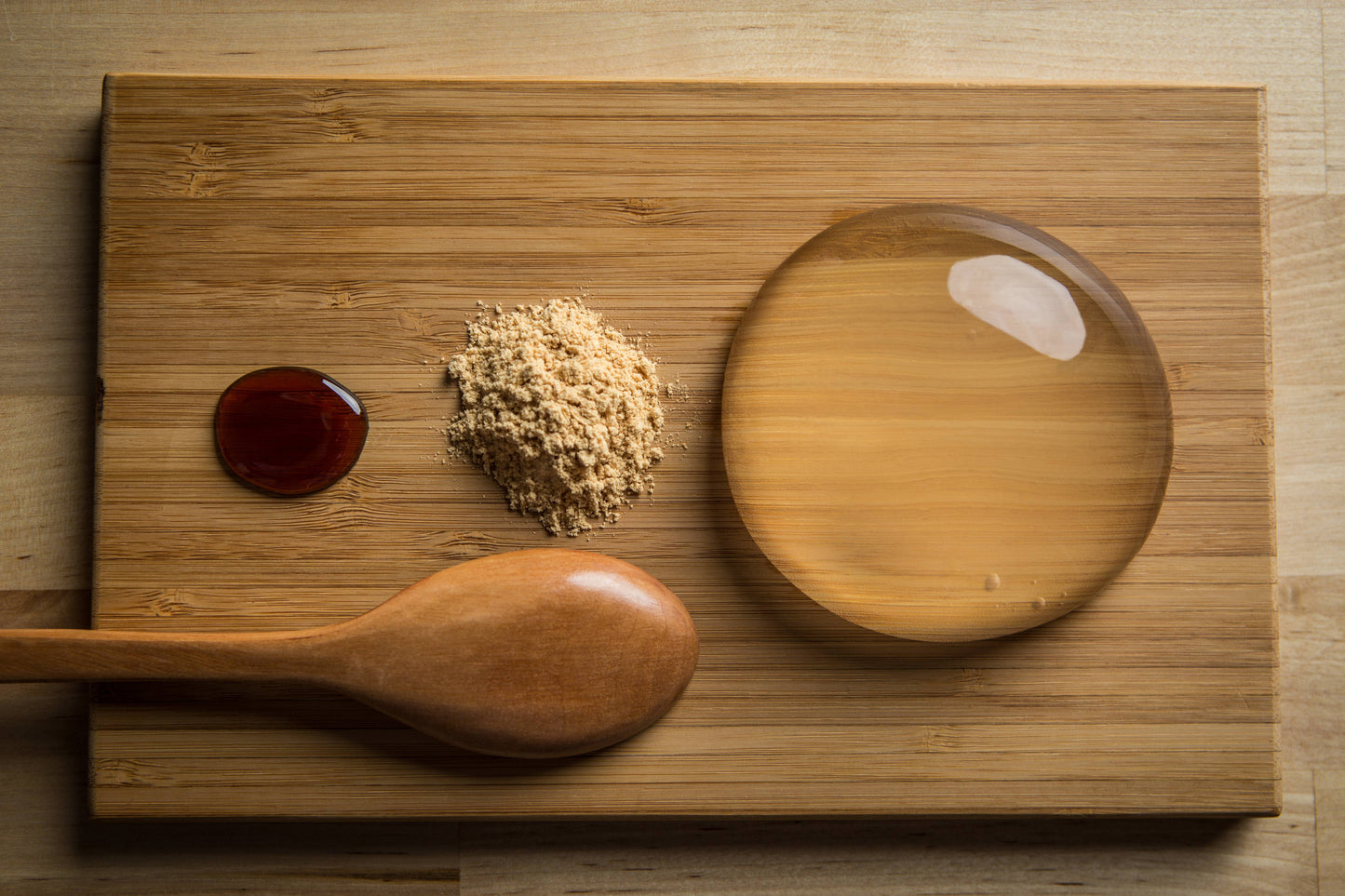 Raindrop Cake, clear jelly dessert on wooden board. Asian dessert made of water and agar. Vegan and vegetarian.