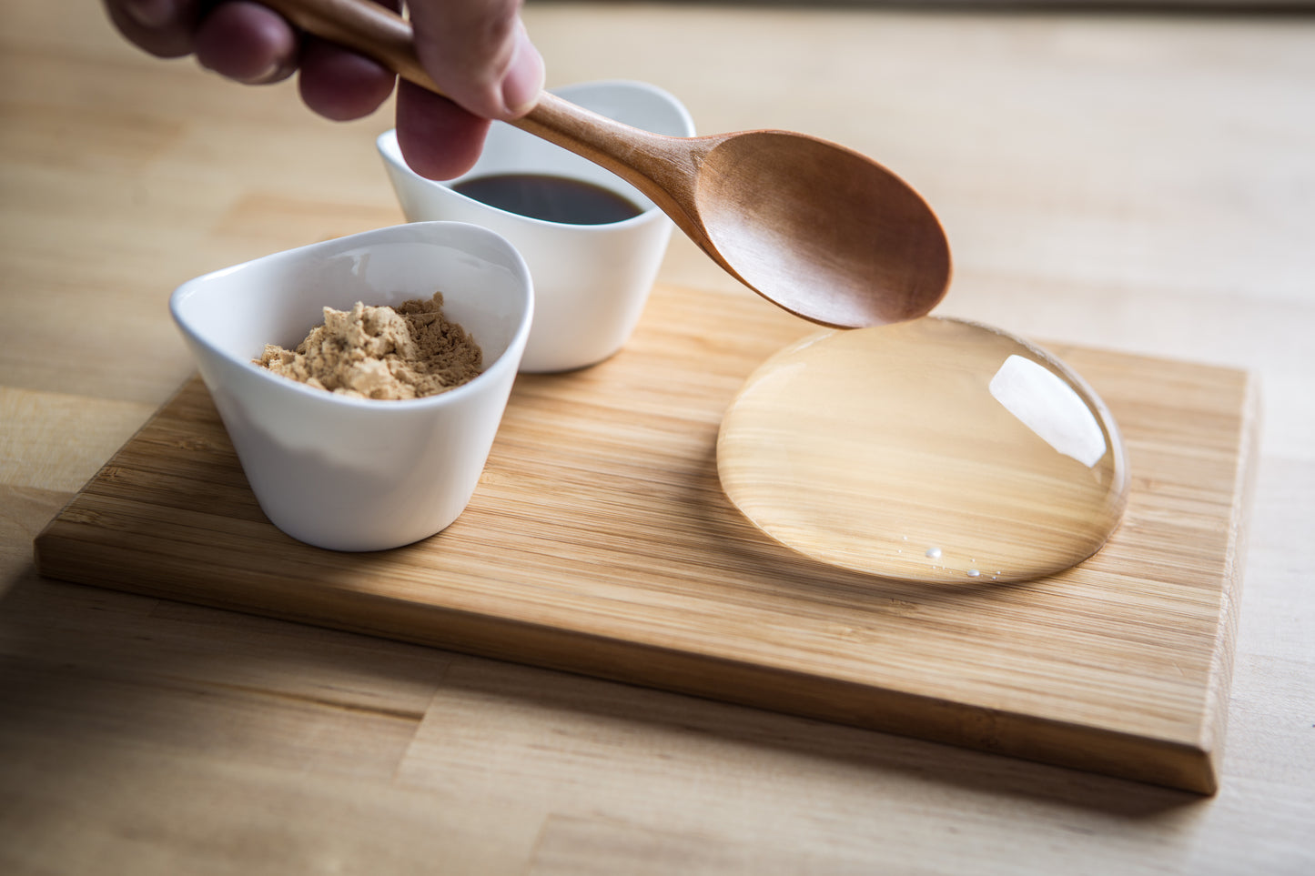 Raindrop Cake, clear jelly dessert on wooden board. Asian dessert made of water and agar. Vegan and vegetarian.